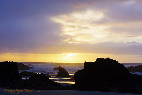 Sunset on The Beach through Lava Rocks