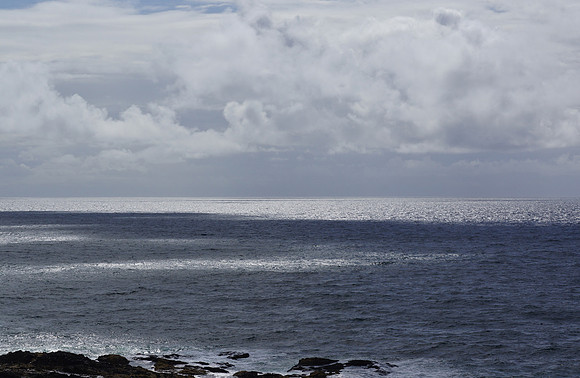 Coastal clouds over pacific with light on ocean