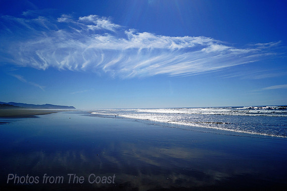 Light Reflects on Beach, Cloud and Ocean