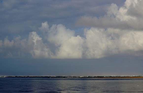 Fluffy Clouds over Bay and Ocean