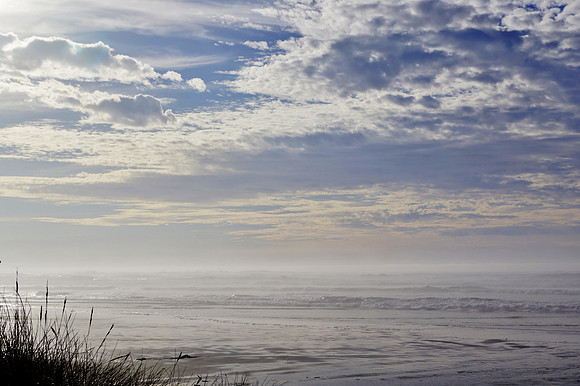 Amazing Sun Lite Clouds over a High Tide Winter Beach
